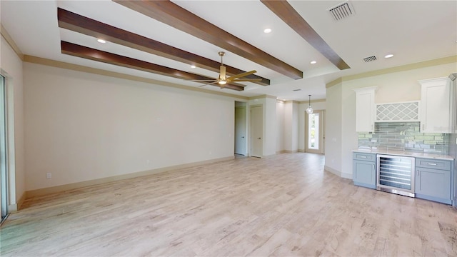 interior space with wine cooler, ceiling fan, decorative backsplash, white cabinetry, and light hardwood / wood-style flooring