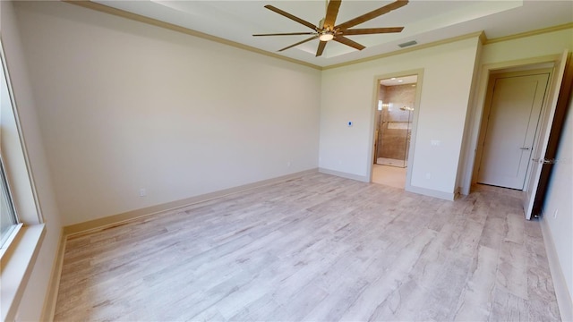 empty room featuring ceiling fan, light wood-type flooring, and ornamental molding