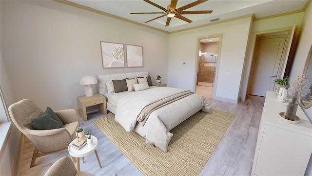 bedroom featuring ceiling fan, crown molding, connected bathroom, and light hardwood / wood-style flooring