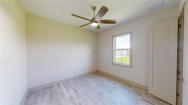 spare room featuring light hardwood / wood-style floors and ceiling fan