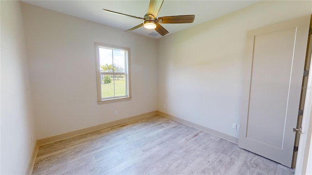 spare room featuring ceiling fan and light wood-type flooring