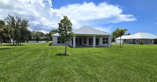 back of property with a lawn