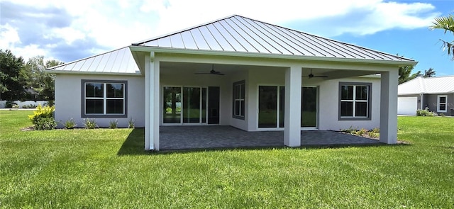 back of house featuring ceiling fan, a yard, and a patio