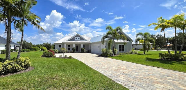 view of front of home with a front lawn and a garage