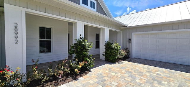 view of exterior entry with a garage