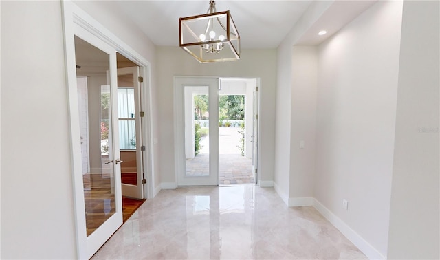 doorway to outside with french doors and a notable chandelier