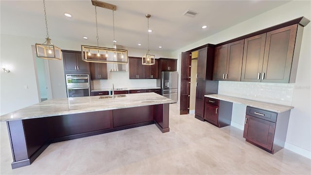 kitchen with stainless steel appliances, hanging light fixtures, and a large island