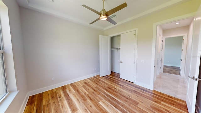 unfurnished bedroom featuring ceiling fan, a closet, and light hardwood / wood-style floors