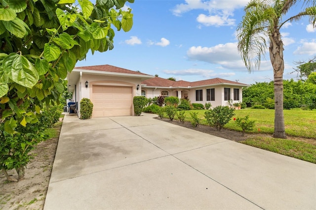 view of front of house with a garage and a front yard