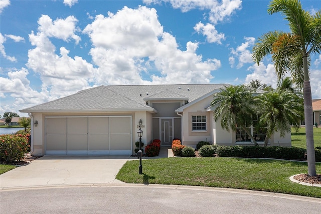 single story home featuring a front yard and a garage