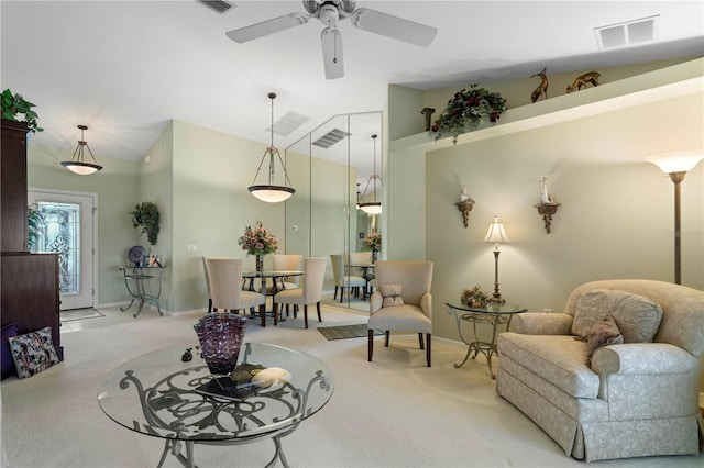 living room featuring ceiling fan, lofted ceiling, and light carpet