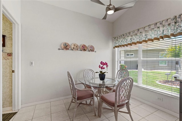 tiled dining area with a wealth of natural light, lofted ceiling, and ceiling fan