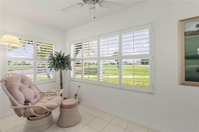 sitting room featuring ceiling fan and light tile patterned floors