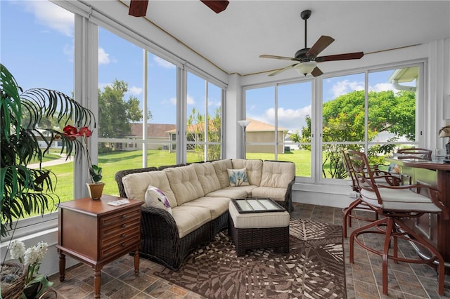 sunroom / solarium featuring ceiling fan