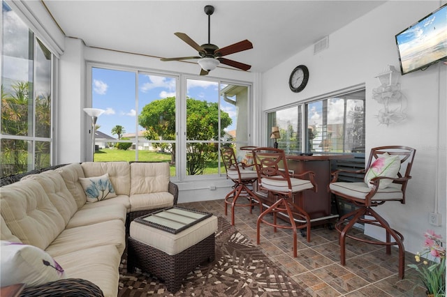 sunroom / solarium featuring ceiling fan and vaulted ceiling