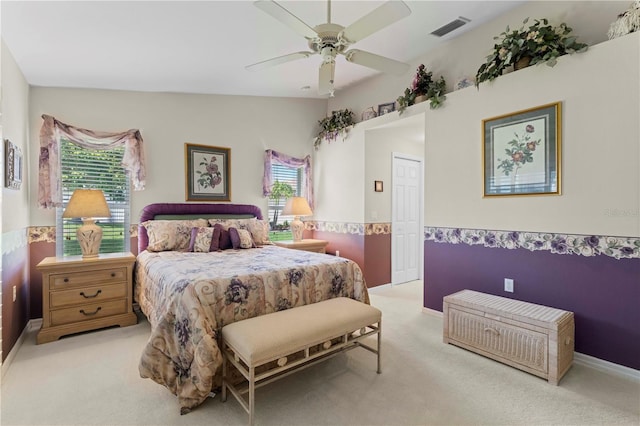 bedroom featuring ceiling fan, light carpet, and a closet