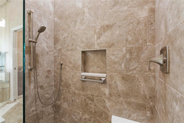 bathroom with tiled shower