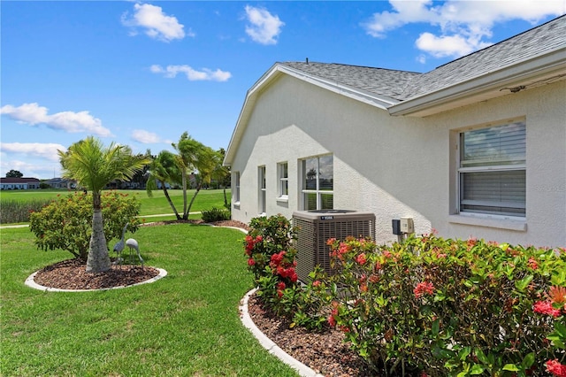 view of property exterior featuring a yard and central air condition unit