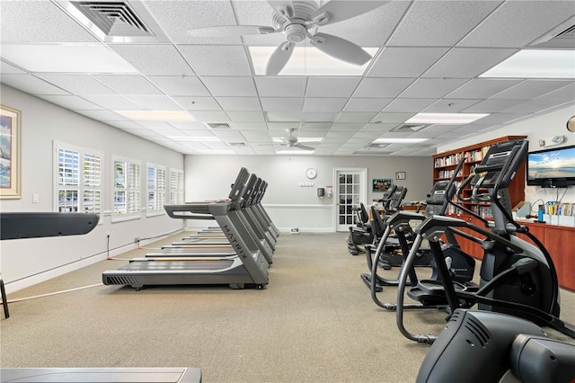 exercise room featuring ceiling fan, a drop ceiling, and carpet floors