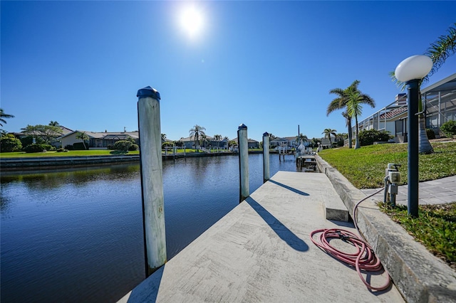 dock area featuring a yard and a water view