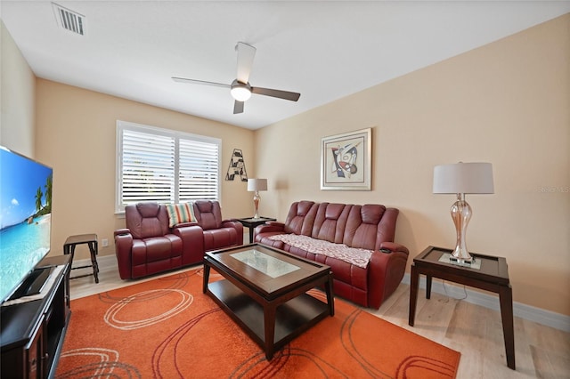 living room with light wood-type flooring and ceiling fan