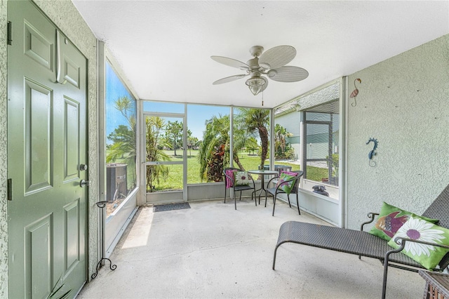 sunroom / solarium with ceiling fan and a healthy amount of sunlight