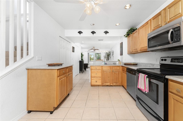 kitchen featuring kitchen peninsula, ceiling fan, light tile patterned floors, and stainless steel appliances