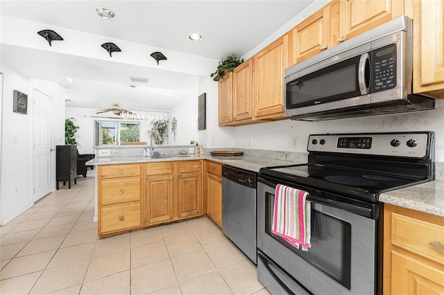 kitchen with ceiling fan, stainless steel appliances, light stone counters, kitchen peninsula, and light tile patterned floors