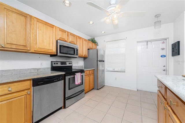 kitchen with ceiling fan, light tile patterned flooring, light stone counters, and stainless steel appliances