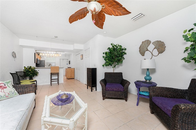 tiled living room featuring a chandelier