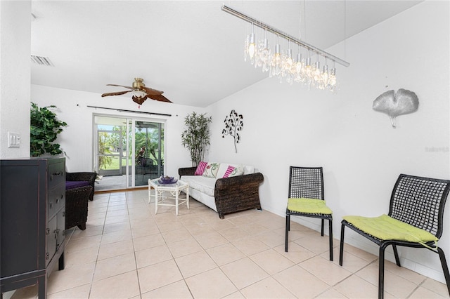 tiled living room featuring ceiling fan and lofted ceiling