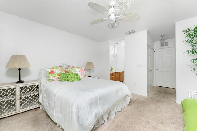 bedroom with a closet, carpet floors, ensuite bathroom, and ceiling fan