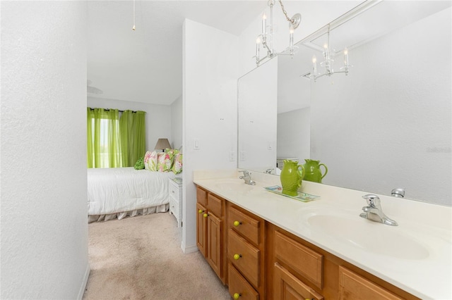 bathroom featuring a chandelier, vanity, and vaulted ceiling