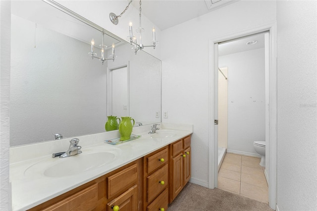 bathroom featuring vanity, a shower, tile patterned flooring, a chandelier, and toilet