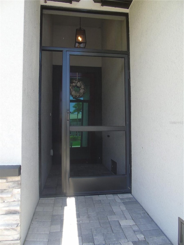 view of exterior entry with stucco siding