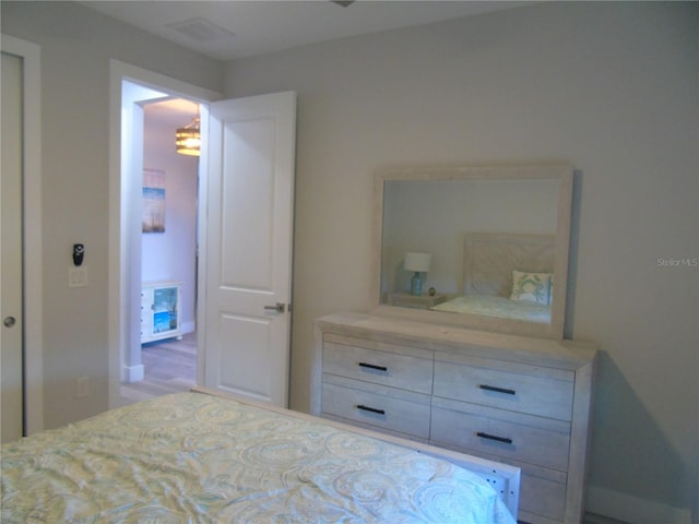 bedroom featuring a notable chandelier