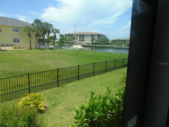 view of yard with fence and a water view