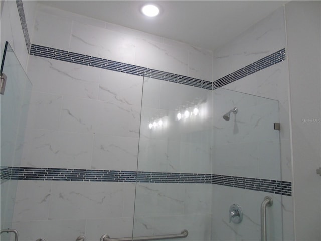 details with a shower with door, recessed lighting, and a tub