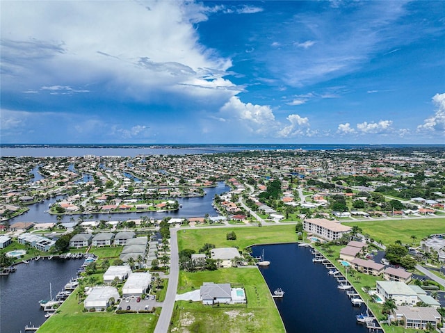 drone / aerial view with a residential view and a water view