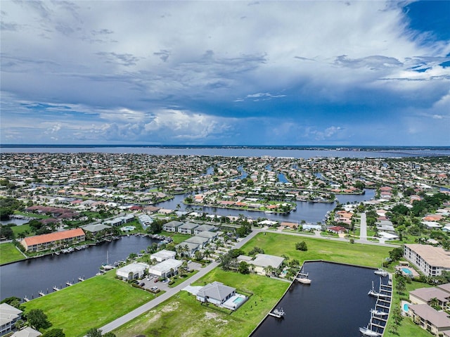 birds eye view of property with a residential view and a water view