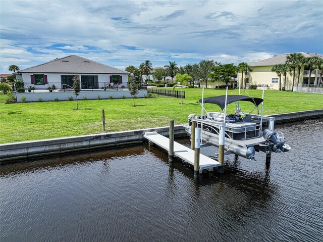 view of dock featuring a lawn, a water view, and boat lift