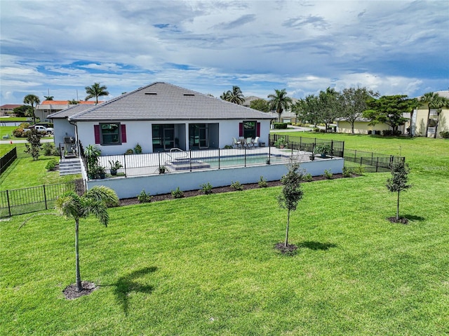 back of property with a lawn, a fenced backyard, and a patio area