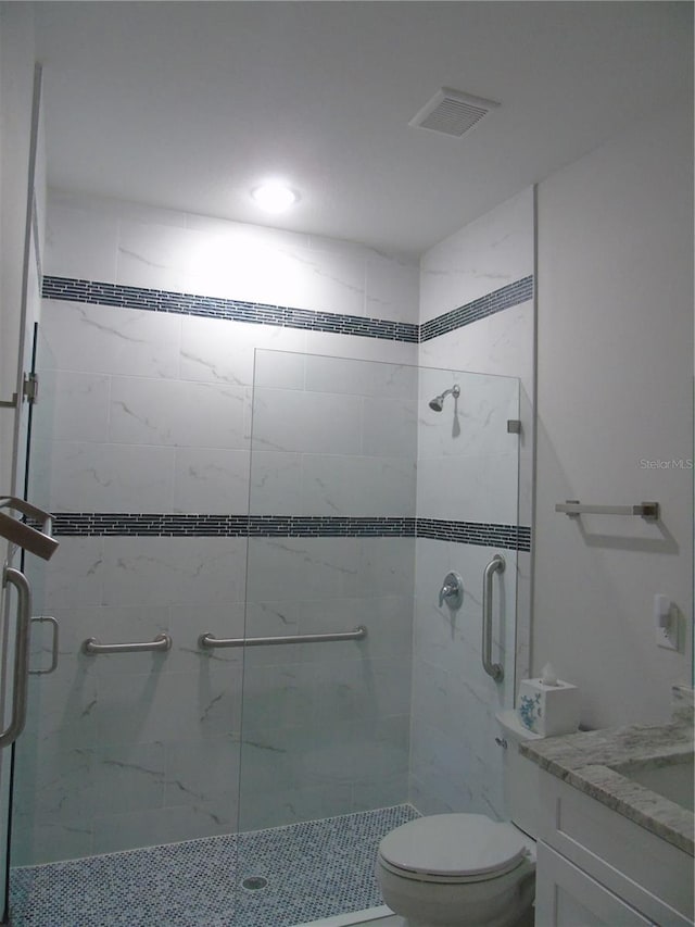 full bath with visible vents, a stall shower, toilet, and vanity