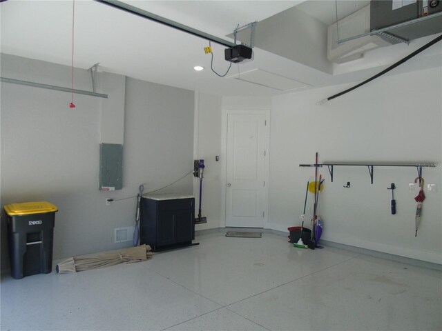 garage with a garage door opener and electric panel