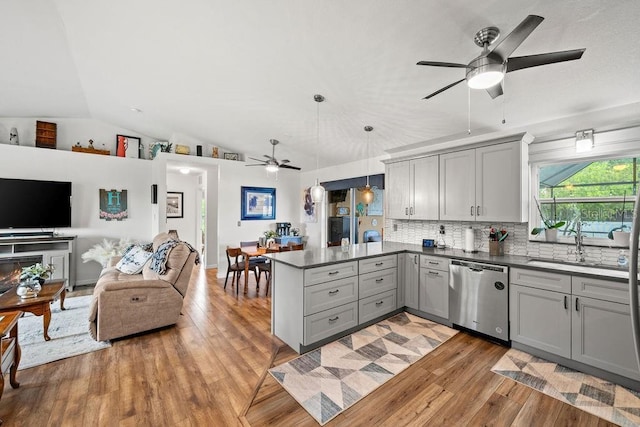 kitchen with gray cabinets, decorative light fixtures, lofted ceiling, stainless steel dishwasher, and kitchen peninsula