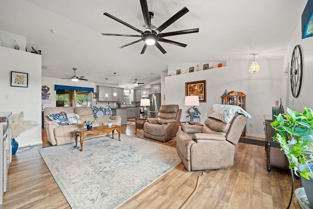 living room with vaulted ceiling and light hardwood / wood-style floors