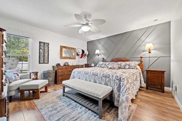 bedroom with wood-type flooring and ceiling fan