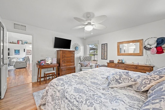 bedroom with ceiling fan and light hardwood / wood-style floors