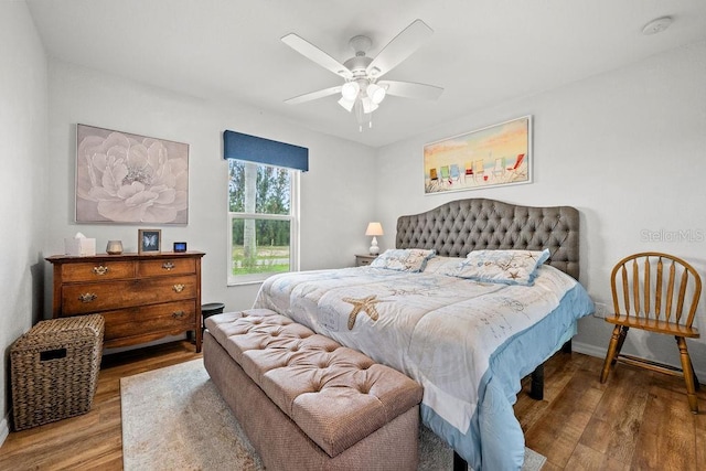 bedroom with hardwood / wood-style floors and ceiling fan