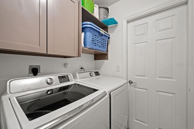 laundry room with cabinets and separate washer and dryer